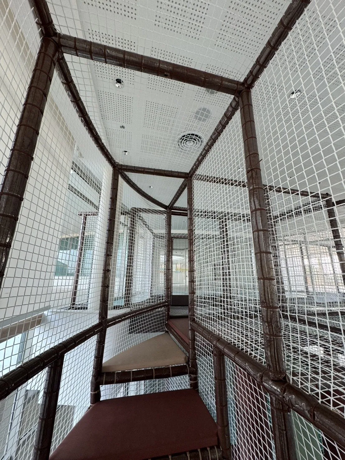 Inside the net tower — layered climbing nets between levels