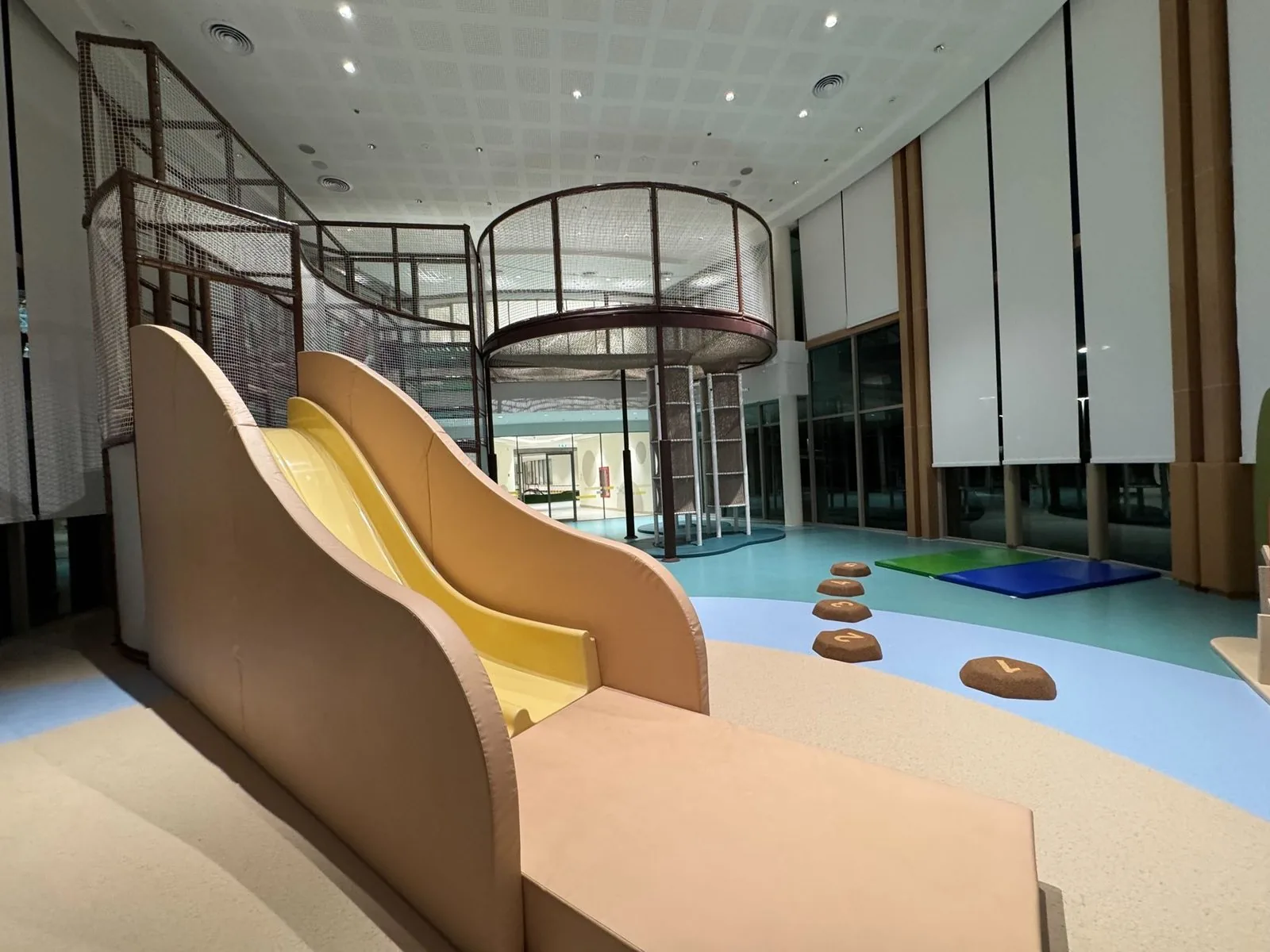 The contain-play tower and twin wave slide over the EPDM river floor